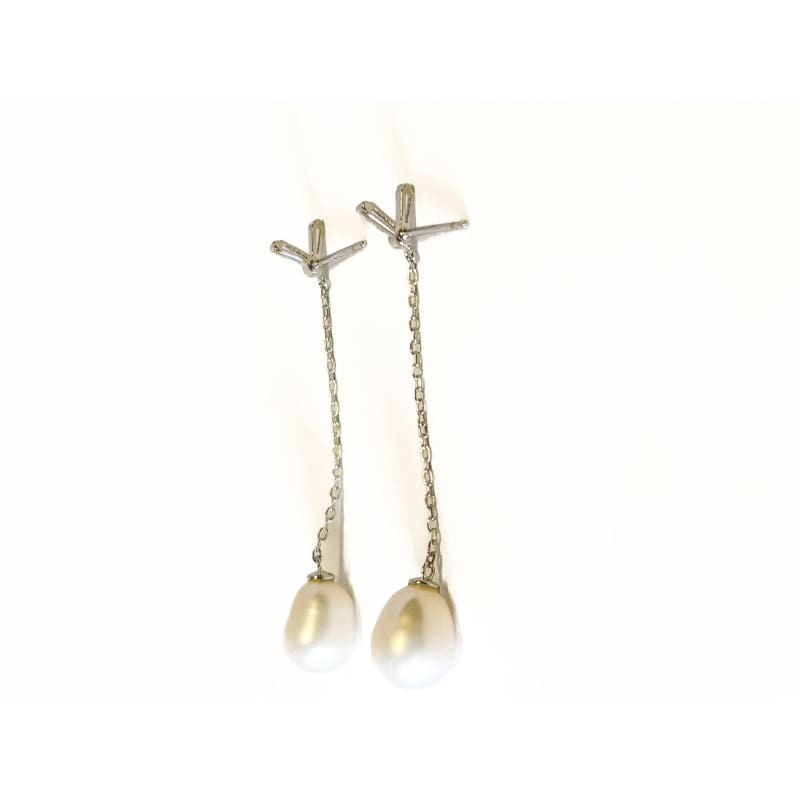 Pair of pearl earrings with chain on a white background